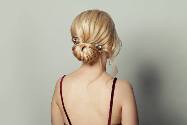 Beautiful female back head with bridal hairdo on white